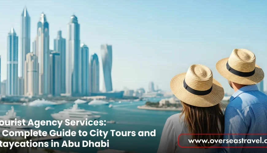A couple wearing straw hats looks out over the Dubai Marina skyline and waterfront, promoting Tourist Agency Services for city tours and staycations in Abu Dhabi via the Overseas Travel website.