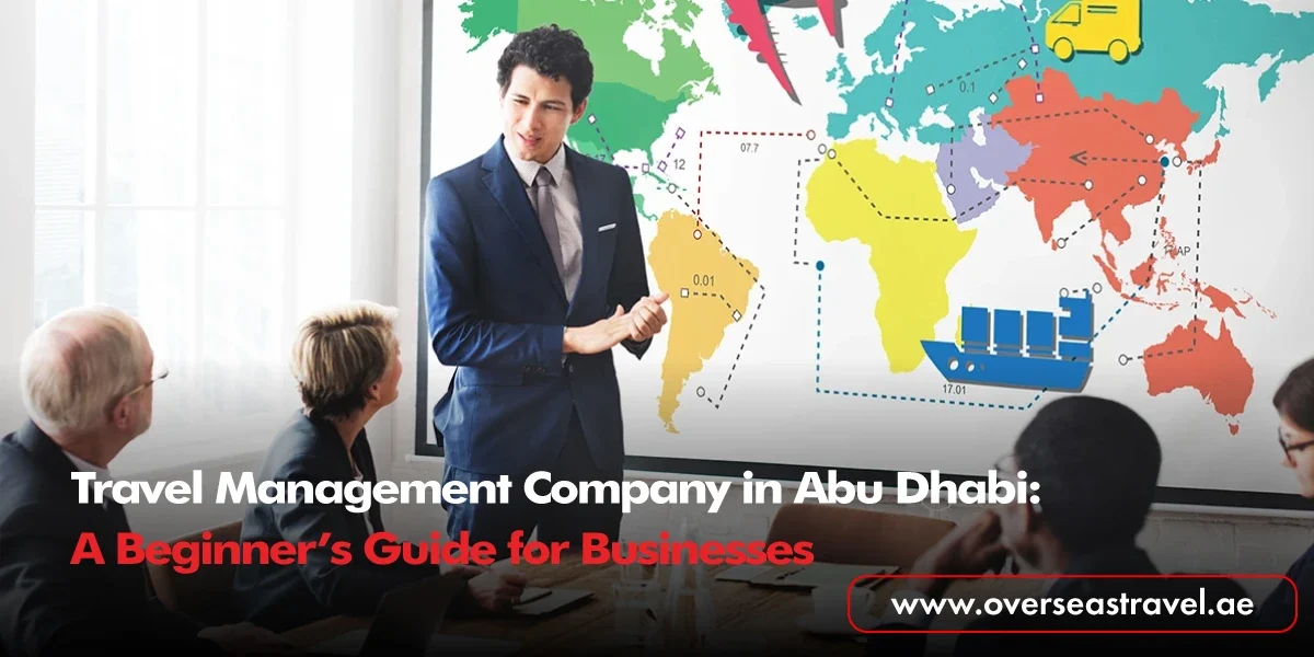 A professional presenter in a suit stands before a world map graphic illustrating global logistics and transport icons, discussing corporate travel solutions with a team in a boardroom.