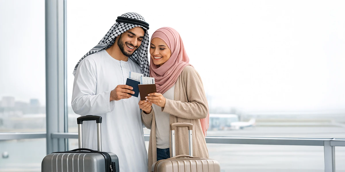 Couple at the airport holding passports and luggage for international travel assistance and visa support services in Abu Dhabi