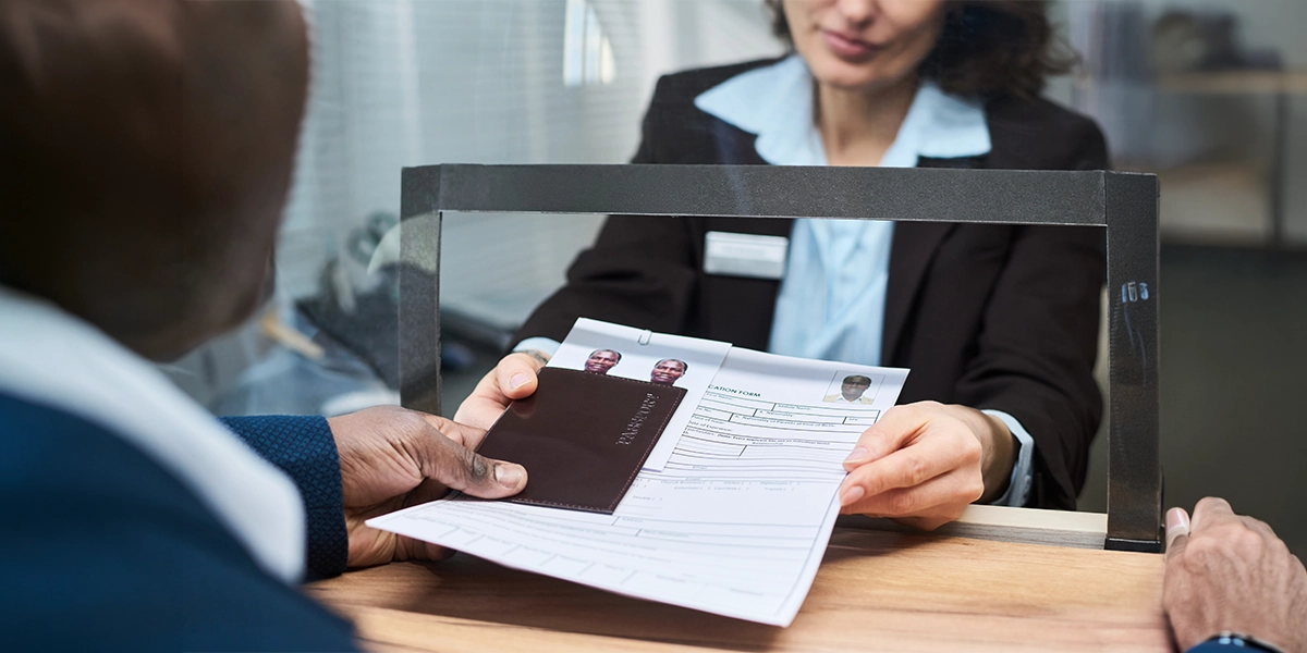 Customer submits passport and visa application documents with the help of travel agency visa assistance